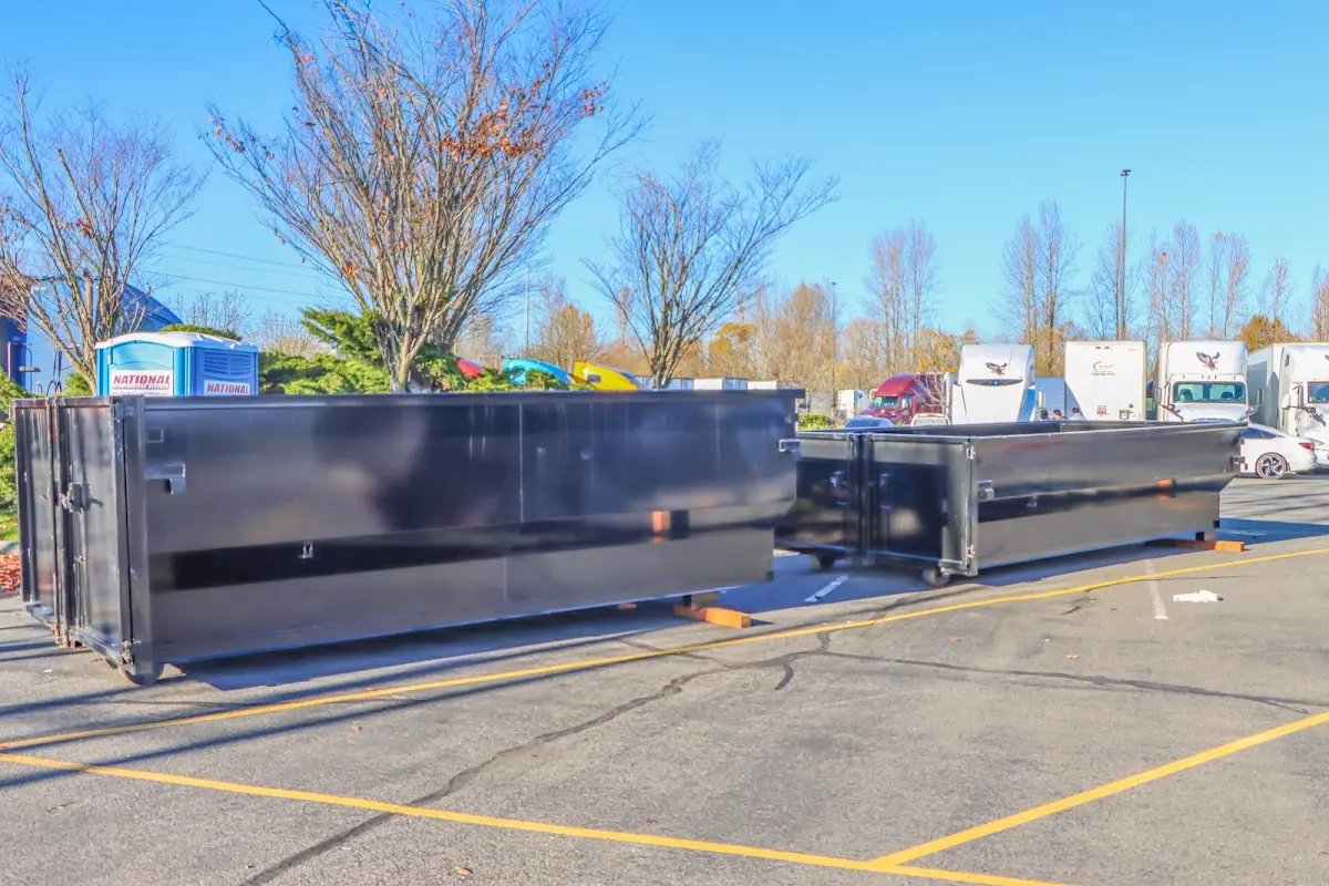 Professional dumpster rental service with roll-off container on residential driveway in South San Gabriel